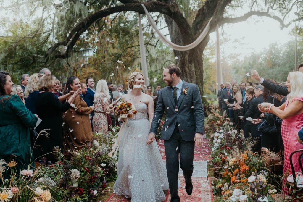 Bride and groom walking up aisle at Magnolia Plantation Wedding in Charleston