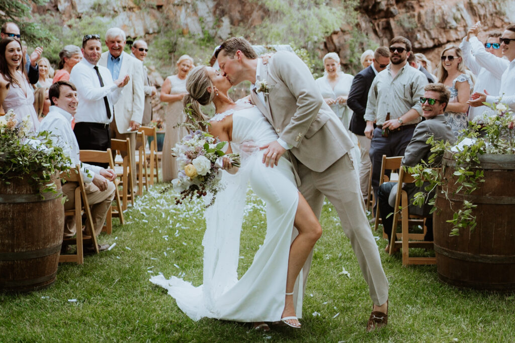 the bride and groom exit the ceremony at their lyons farmette wedding