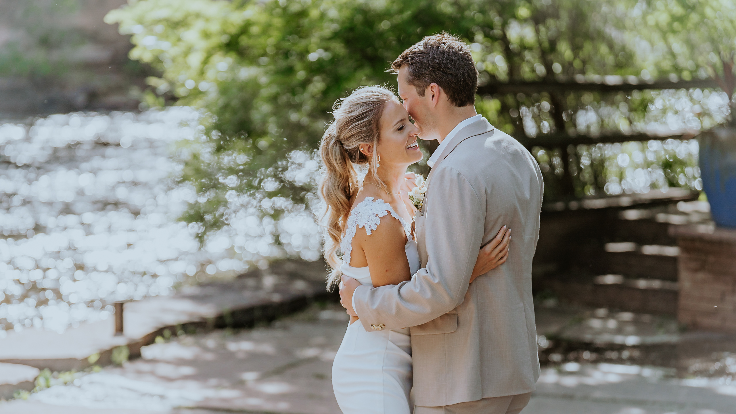 A bride and groom share their first dance along the river at their lyons farmette wedding