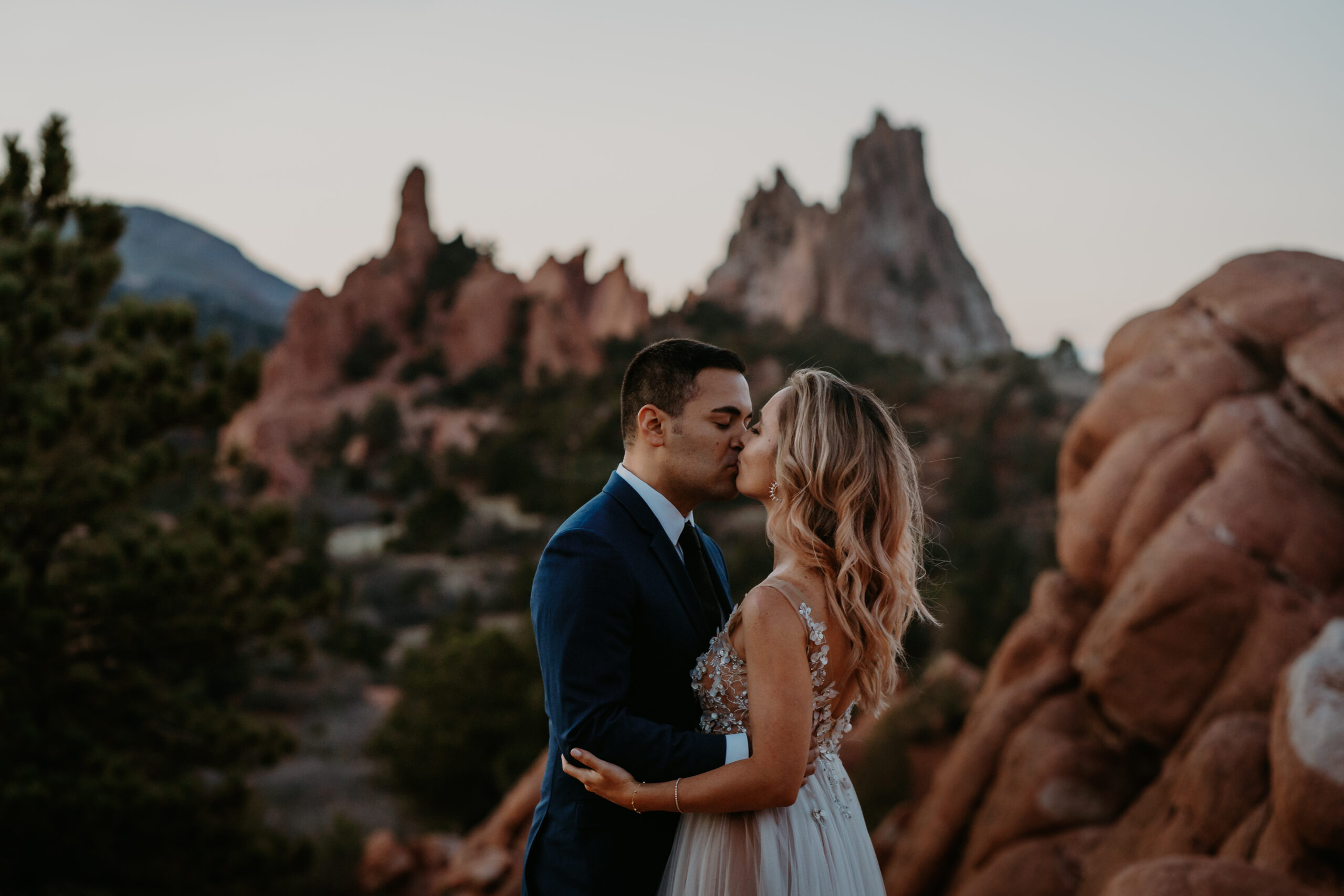 couple shares their first kiss at their garden of the gods elopement