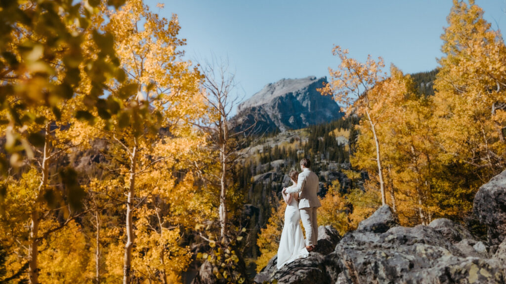 couple looks off into the distance at their fall elopement in colorado. fall elopement guide