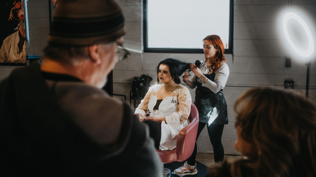 bride getting ready at the salon with family before elopement